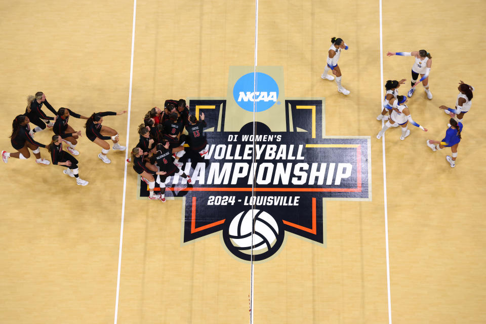 LOUISVILLE, KENTUCKY - DECEMBER 19: The Louisville Cardinals celebrate their victory over the Pitt Panthers during the Division I Women's Volleyball Semifinals held at the KFC YUM! Center on December 19, 2024 in Louisville, Kentucky. (Photo by Jamie Schwaberow/NCAA Photos via Getty Images)