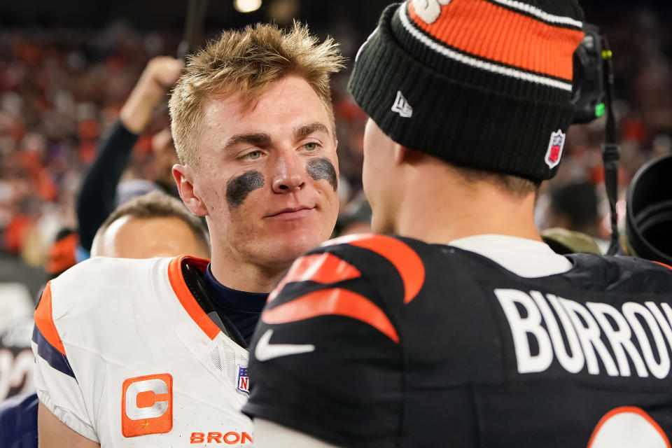 CINCINNATI, OHIO - DECEMBER 28: Bo Nix #10 of the Denver Broncos and Joe Burrow #9 of the Cincinnati Bengals meet after the Bengals beat the Broncos 30-24 in overtime at Paycor Stadium on December 28, 2024 in Cincinnati, Ohio. (Photo by Dylan Buell/Getty Images)