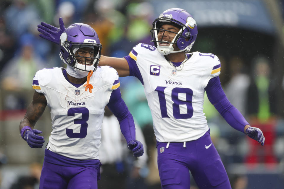 SEATTLE, WASHINGTON - DECEMBER 22: Justin Jefferson #18 of the Minnesota Vikings celebrates with Jordan Addison #3 after Addison scored a touchdown in the first quarter of a game against the Seattle Seahawks at Lumen Field on December 22, 2024 in Seattle, Washington. (Photo by Steph Chambers/Getty Images)