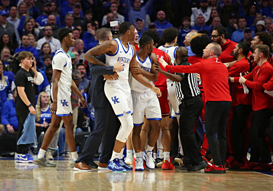 LEXINGTON, KY - DECEMBER 14: Coaches and officials attempt to break up a fight in a game between the Louisville Cardinals and the Kentucky Wildcats on December 14, 2024, at Rupp Arena in Lexington, KY. (Photo by Jeff Moreland/Icon Sportswire via Getty Images)