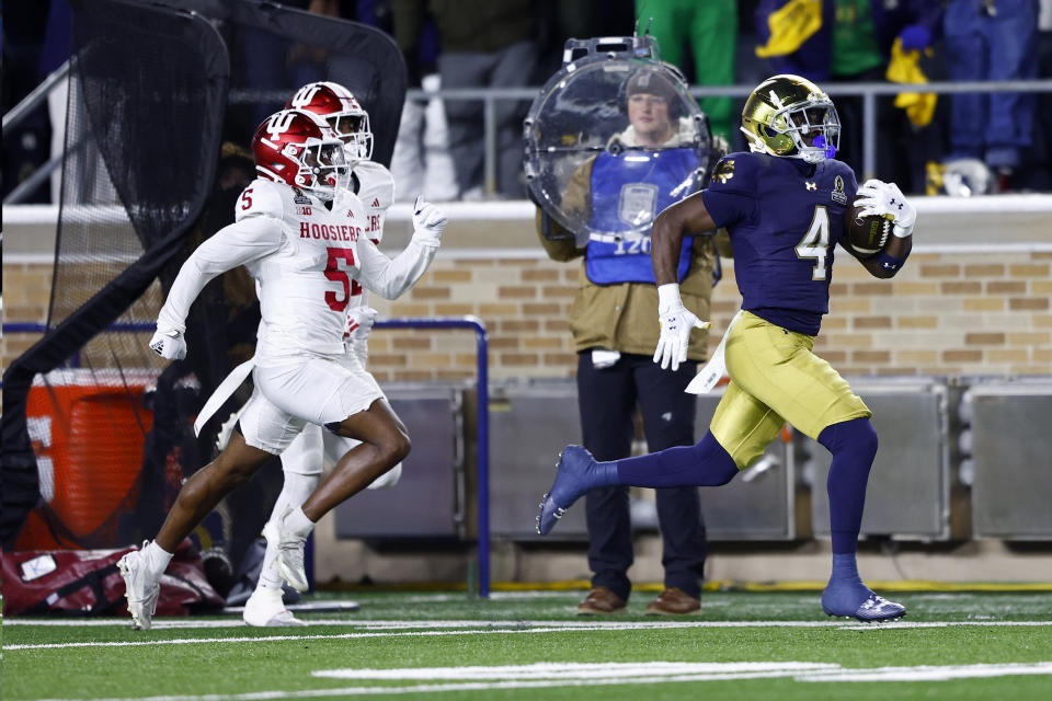 SOUTH BEND, IN - DECEMBER 20: Notre Dame Fighting Irish running back Jeremiyah Love (4) runs down the sideline and goes in for the touchdown in the first quarter of play during the CFP first round game between the Indiana Hoosiers and Notre Dame Fighting Irish on December 20, 2024 at Notre Dame Stadium in South Bend, IN. (Photo by Jeffrey Brown/Icon Sportswire via Getty Images)