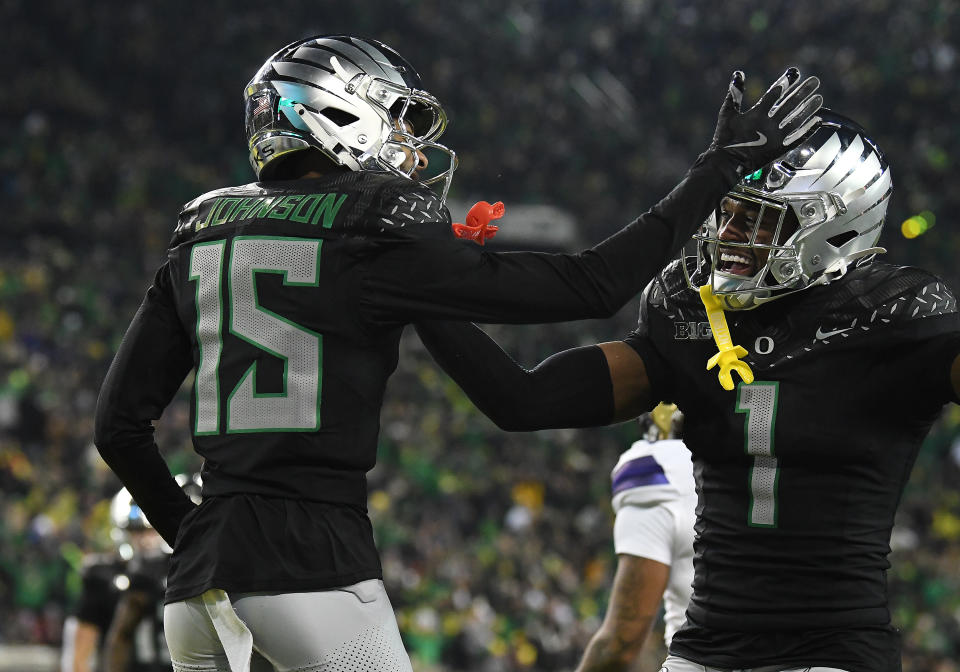 EUGENE, OR - NOVEMBER 30: Oregon Ducks wide receiver Tez Johnson (15) celebrates a touchdown with Oregon Ducks wide receiver Traeshon Holden (1) during a college football game between the Washington Huskies and Oregon Ducks on November 30, 2024 at Autzen Stadium in Eugene, Oregon. (Photo by Brian Murphy/Icon Sportswire via Getty Images)