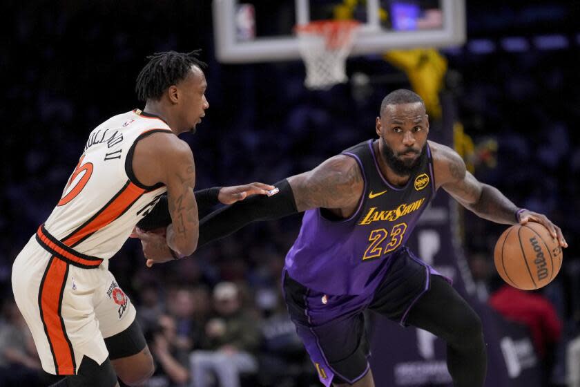 Los Angeles Lakers forward LeBron James (23) dribbles against Detroit Pistons forward Ronald Holland II.