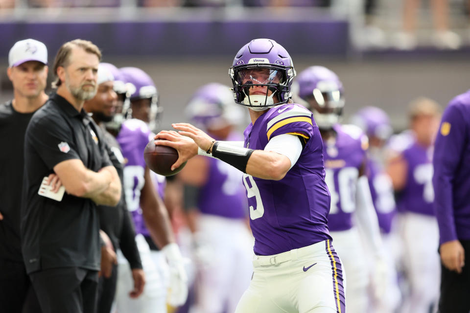 MINNEAPOLIS, MINNESOTA - AUGUST 10: Minnesota Vikings Offensive Coordinator Wes Phillips watches J.J. McCarthy #9 of the Minnesota Vikings warm up before the pre-season game against Las Vegas Raiders at U.S. Bank Stadium on August 10, 2024 in Minneapolis, Minnesota. J.J. McCarthys season was cut short due to a knee injury in the preseason game. (Photo by Adam Bettcher/Getty Images)