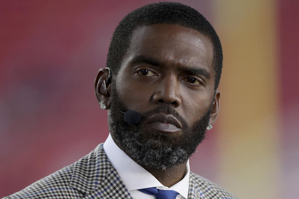 FILE - Broadcaster Randy Moss sits on the sideline before an NFL football game between the San Francisco 49ers and the Los Angeles Rams, Monday, Nov. 15, 2021, in Santa Clara, Calif. (AP Photo/Scot Tucker, File)