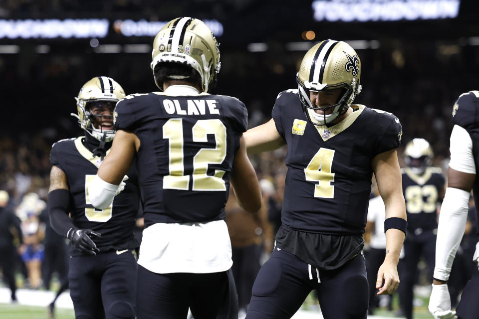 NEW ORLEANS, LOUISIANA - NOVEMBER 05: Chris Olave #12 of the New Orleans Saints celebrates with Derek Carr #4 after a touchdown during the first quarter in the game against the Chicago Bears at Caesars Superdome on November 05, 2023 in New Orleans, Louisiana. (Photo by Wesley Hitt/Getty Images)