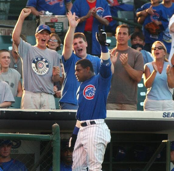 Chicago Cubs' Sammy Sosa, center front, waves to fans after hitting a home run in 2002.