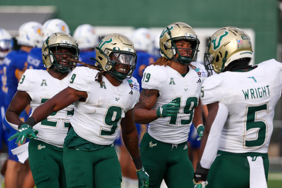 HONOLULU, HAWAII - DECEMBER 24: Ta'Ron Keith #9 of the South Florida Bulls celebrates with Nay'Quan Wright #5 after scoring a touchdown during the first half of the game against the San Jose Spartans at the Clarence T.C. Ching Athletics Complex on December 24, 2024 in Honolulu, Hawaii. (Photo by Darryl Oumi/Getty Image