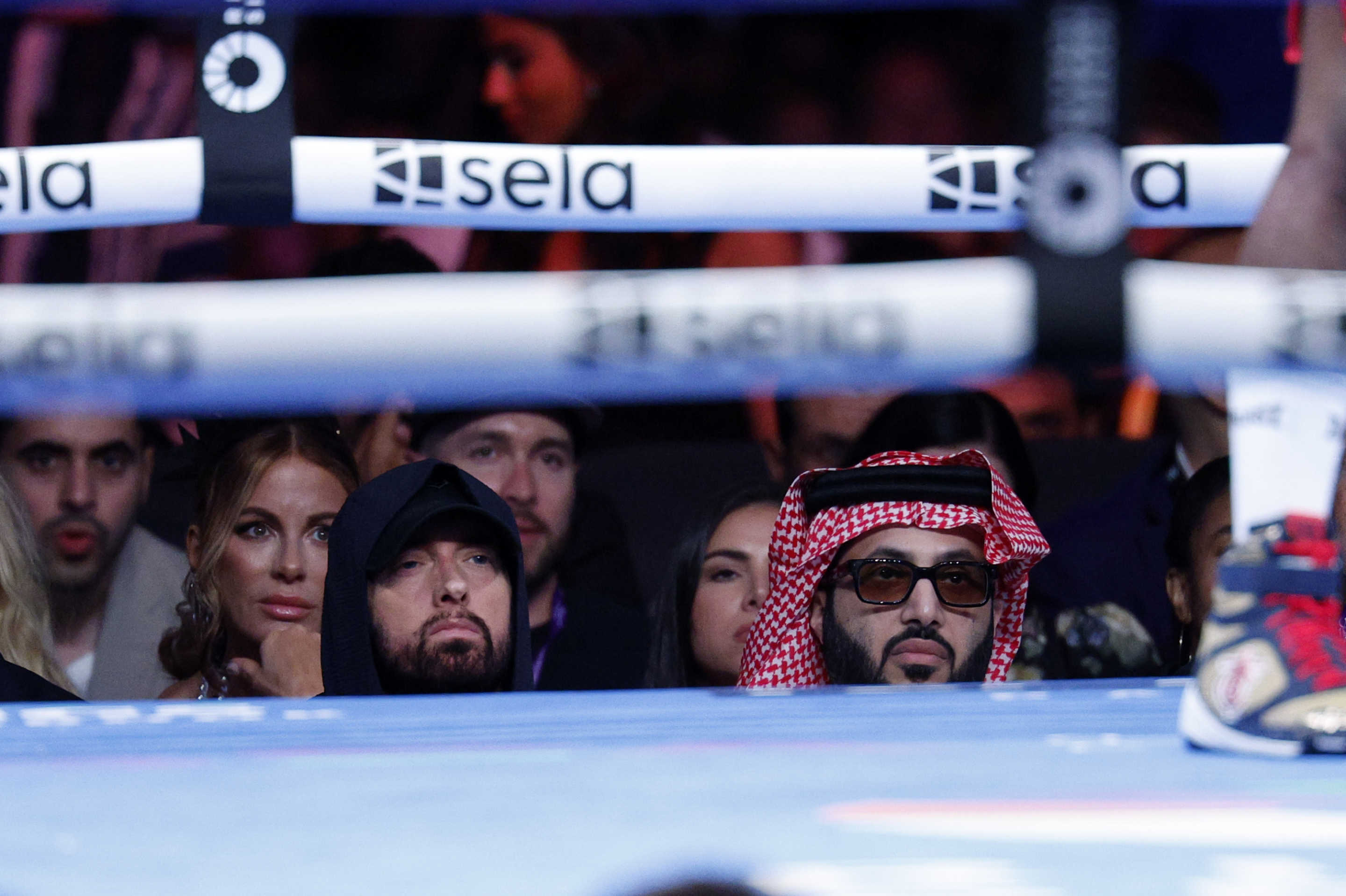 LOS ANGELES, CALIFORNIA - AUGUST 3: From left tonight, Kate Beckinsale, Eminem, and Turki Alalshikh, the chairman of Saudi Arabia's General Entertainment Authority, seated ringside attend Terence Crawford and Israel Madrimov WBA junior middleweight title bout at BMO Stadium on August 3, 2024 in Los Angeles, California. (Photo by Kevork Djansezian/Getty Images)