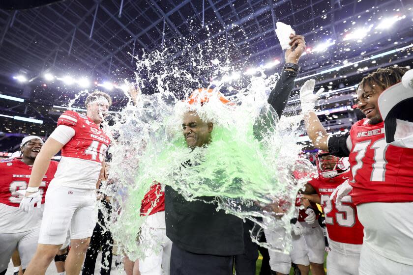 UNLV interim head coach Del Alexander is doused in a sports drink after leading the Rebels to an L.A. Bowl win over Cal