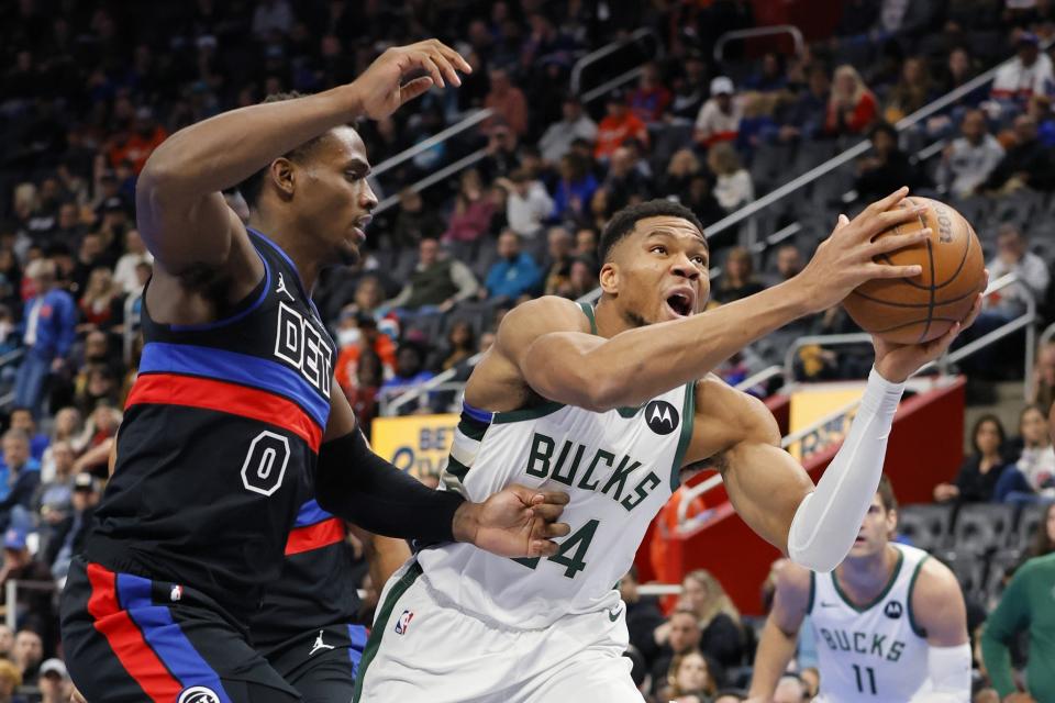 Milwaukee Bucks forward Giannis Antetokounmpo (34) goes to the basket past Detroit Pistons center Jalen Duren (0) during the first half of an Emirates NBA Cup basketball game Tuesday, Dec. 3, 2024, in Detroit. (AP Photo/Duane Burleson)