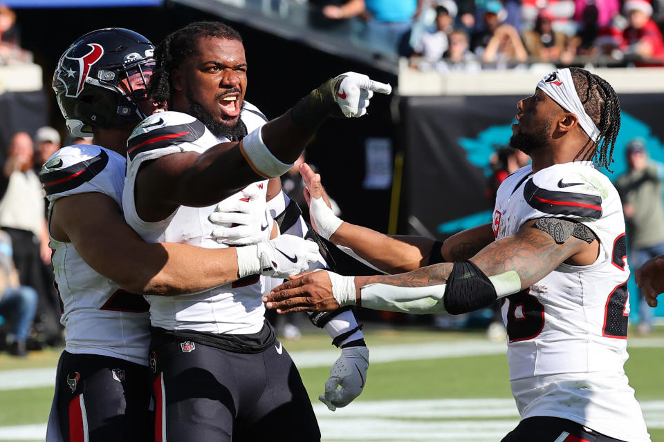 Azeez Al-Shaair of the Houston Texans points to the Jacksonville Jaguars bench after a fight and being ejected. (Photo by Mike Carlson/Getty Images)