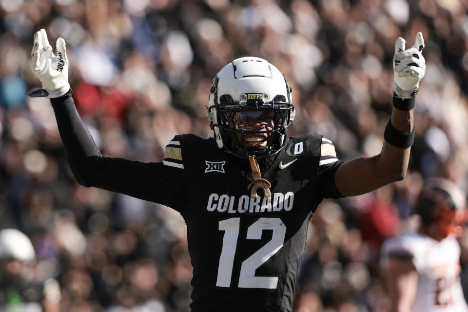 Travis Hunter celebrates one of his three touchdown catches during Friday's 52-0 win over Oklahoma State. (Andrew Wevers/Getty Images)