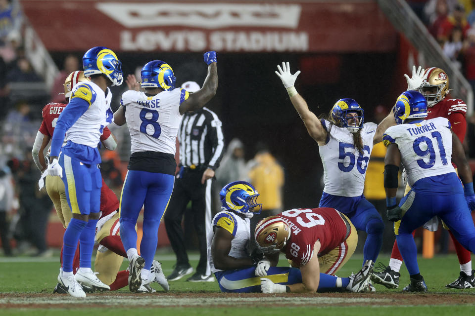 The Rams celebrate after a game-clinching sack. (Ezra Shaw/Getty Images)