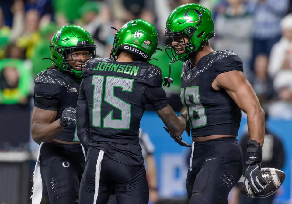 INDIANAPOLIS, INDIANA - DECEMBER 7: Noah Whittington #6, Tez Johnson #15 and Kenyon Sadiq #18 of the Oregon Ducks celebrate a touchdown against the Penn State Nittany Lions during the Big Ten Championship at Lucas Oil Stadium on December 7, 2024 in Indianapolis, Indiana. (Photo by Michael Hickey/Getty Images)