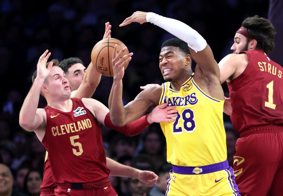 Laker Rui Hachimura has the ball stripped away by Cavalier Max Struss as Sam Merrill tries to grab the ball