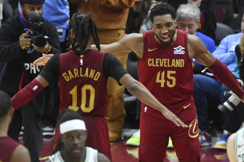 Dec 1, 2024; Cleveland, Ohio, USA; Cleveland Cavaliers guard Darius Garland (10) and guard Donovan Mitchell (45) celebrate a win over the Boston Celtics at Rocket Mortgage FieldHouse. Mandatory Credit: David Richard-Imagn Images