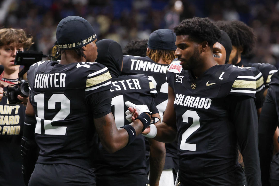 SAN ANTONIO, TX - DECEMBER 28: Colorado Buffaloes quarterback Shedeur Sanders (2) and Colorado Buffaloes wide receiver Travis Hunter (12) high five each other before the football game between BYU Cougars and Colorado Buffalos on December 28, 2024, at the Alamodome in San Antonio, Texas. (Photo by David Buono/Icon Sportswire via Getty Images)