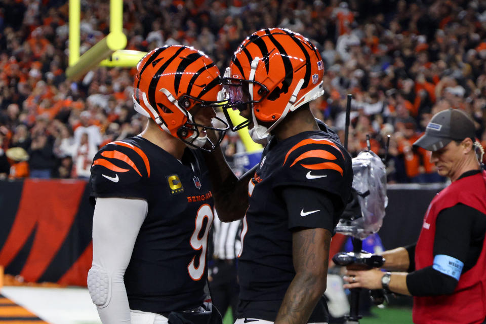 Dec 28, 2024; Cincinnati, Ohio, USA; Cincinnati Bengals quarterback Joe Burrow (9) celebrates following his touchdown pass to wide receiver Tee Higgins (5) during the fourth quarter against the Denver Broncos at Paycor Stadium. Mandatory Credit: Joseph Maiorana-Imagn Images