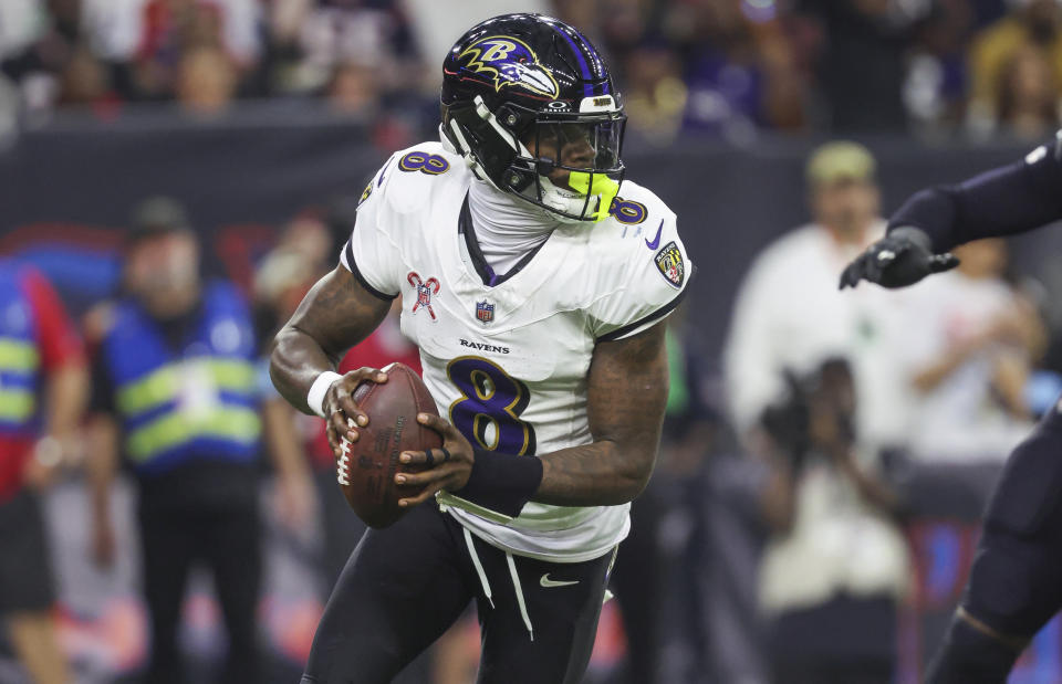 Dec 25, 2024; Houston, Texas, USA; Baltimore Ravens quarterback Lamar Jackson (8) rolls out of the pocket with the ball during the game against the Houston Texans at NRG Stadium. Mandatory Credit: Troy Taormina-Imagn Images