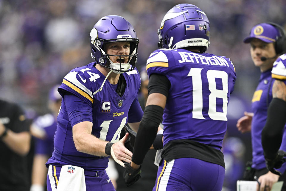 MINNEAPOLIS, MINNESOTA - DECEMBER 8: Quarterback Sam Darnold #14 of the Minnesota Vikings celebrates with Justin Jefferson #18 after throwing him a touchdown pass in the second quarter of the game against the Atlanta Falcons at U.S. Bank Stadium on December 8, 2024 in Minneapolis, Minnesota. The Vikings defeated the Falcons 42-21. (Photo by Stephen Maturen/Getty Images)