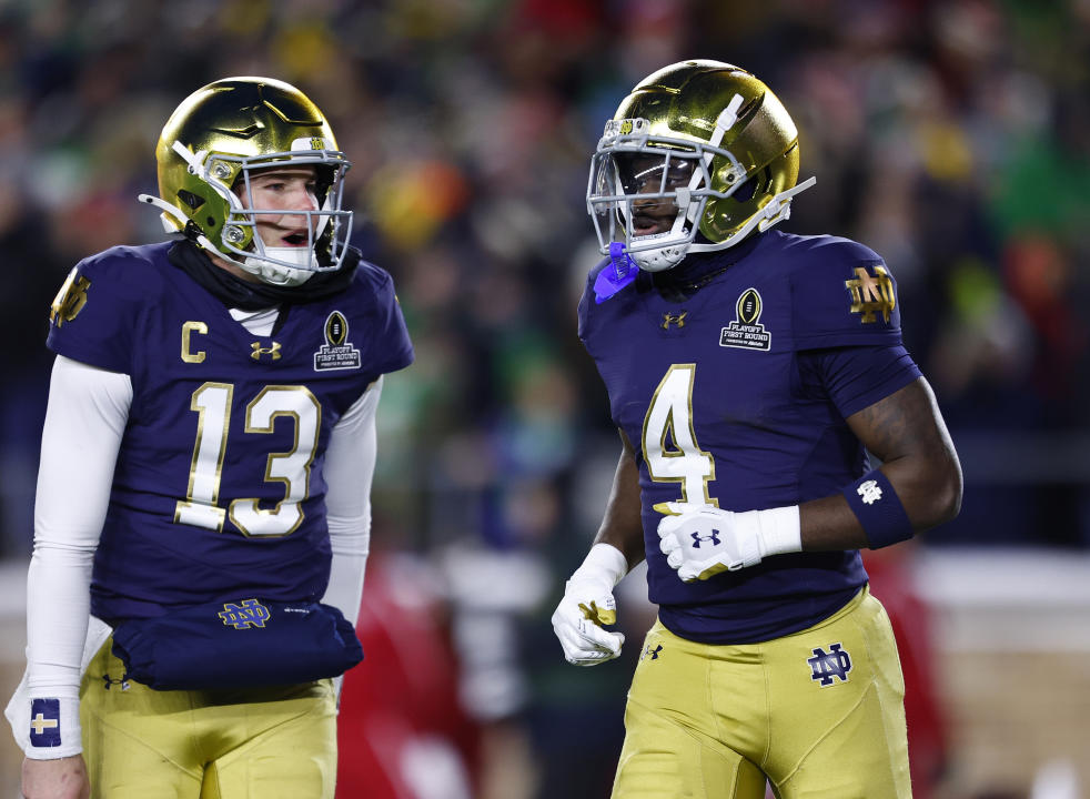 SOUTH BEND, IN - DECEMBER 20: Notre Dame Fighting Irish quarterback Riley Leonard (13) celebrates Notre Dame Fighting Irish running back Jeremiyah Love (4) touchdown during the CFP first round game between the Indiana Hoosiers and Notre Dame Fighting Irish on December 20, 2024 at Notre Dame Stadium in South Bend, IN. (Photo by Jeffrey Brown/Icon Sportswire via Getty Images)