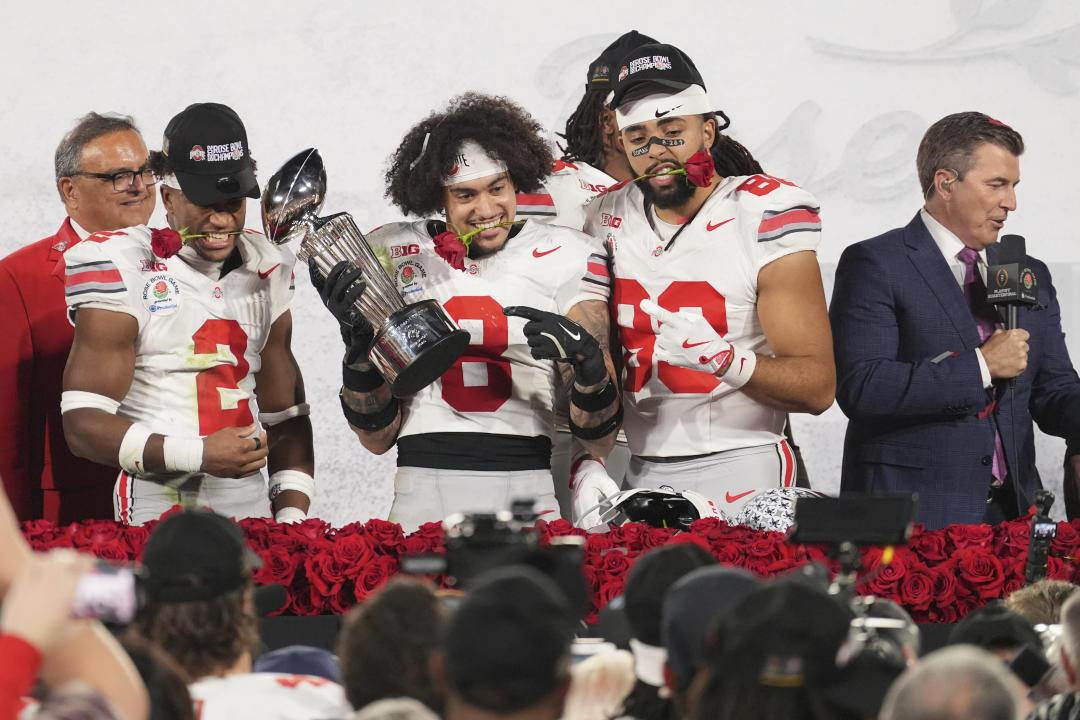 Ohio State safety Lathan Ransom (8) and tight end Gee Scott Jr. (88) celebrate with the trophy after the quarterfinals of the Rose Bowl College Football Playoff against Oregon, Wednesday, Jan. 1, 2025, in Pasadena, Calif. (AP Photo/Mark J. Terrill)