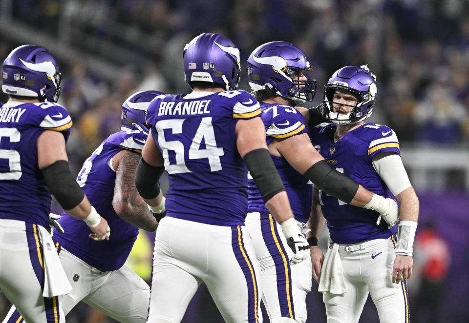 MINNEAPOLIS, MINNESOTA - DECEMBER 29: Quarterback Sam Darnold #14 of the Minnesota Vikings celebrates with Brian O'Neill #75 after a throwing a touchdown pass during the third quarter against the Green Bay Packers at U.S. Bank Stadium on December 29, 2024 in Minneapolis, Minnesota. (Photo by Stephen Maturen/Getty Images)