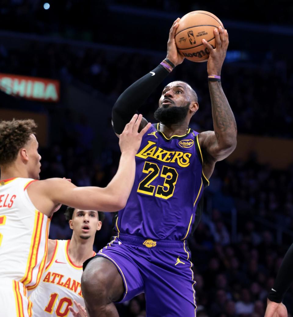 Lakers star LeBron James drives to the basket against Atlanta's Dyson Daniels in the first half Friday.