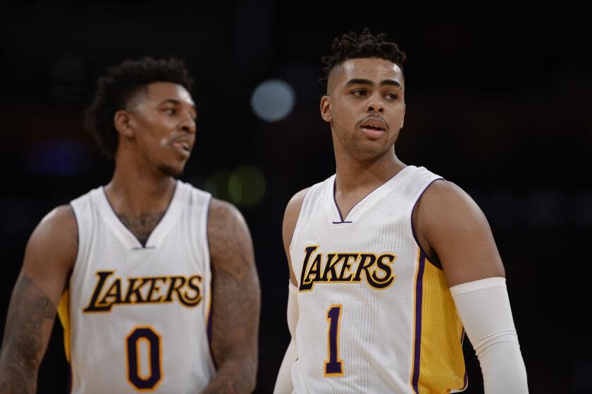 Los Angeles Lakers guard Nick Young (0) and teammate D'Angelo Russell (1) stand near each other during a game