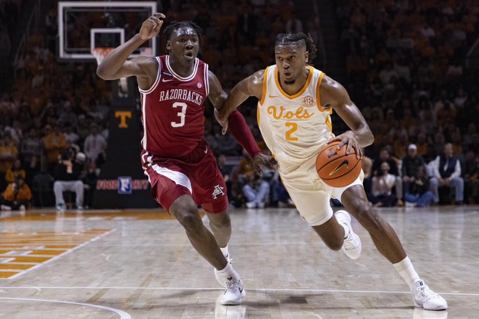 Tennessee guard Chaz Lanier (2) drives against Arkansas forward Adou Thiero (3) during the first half of an NCAA college basketball game Saturday, Jan. 4, 2025, in Knoxville, Tenn. (AP Photo/Wade Payne)