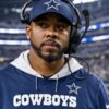 Christian Parker wearing a Dallas Cowboys cap and coaching headset in a library image.